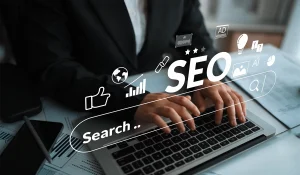 A close-up view of hands typing on a laptop keyboard, featuring an overlay of a digital search bar and floating icons representing search engine optimization, highlighting the data-driven approach of SEO Services in Dubai.